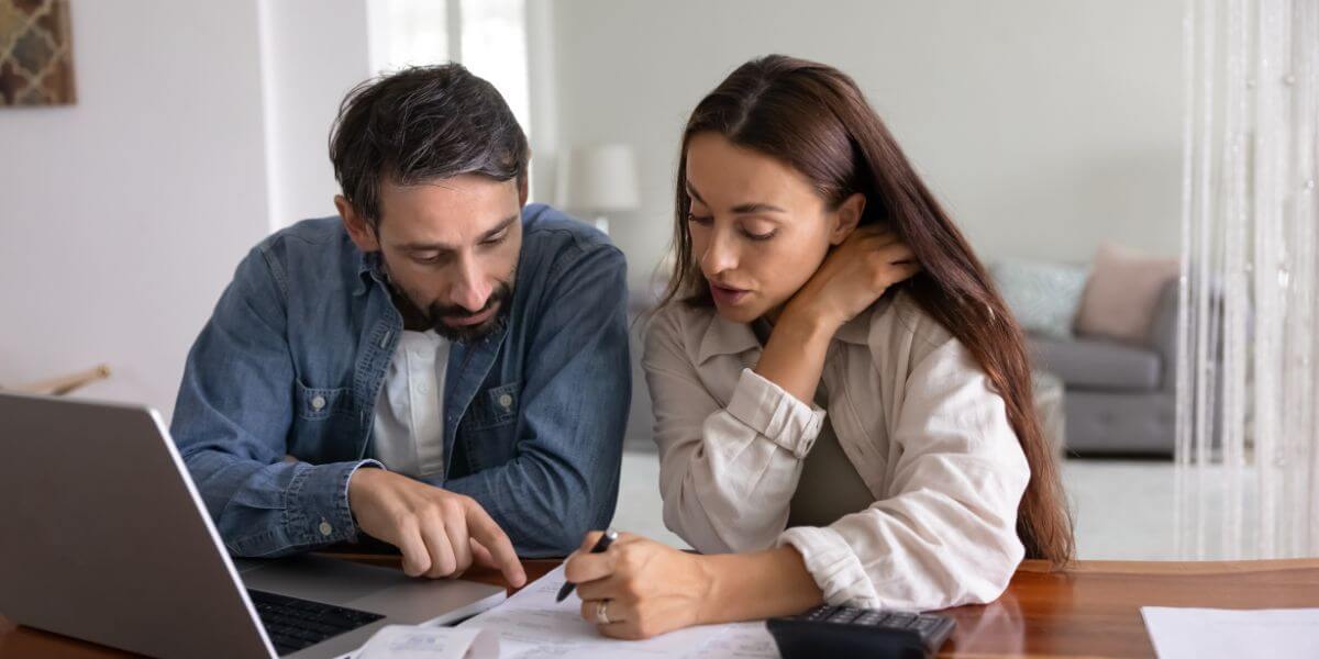 Internet bill negotiation man and woman looking at papers