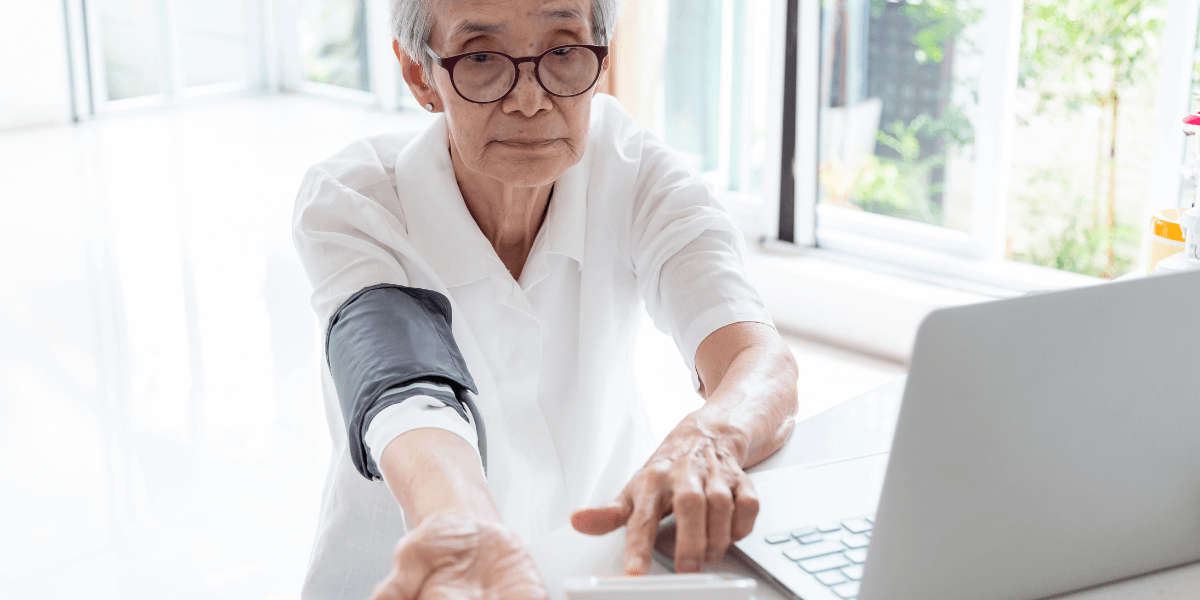 woman using telemedicine to take blood pressure