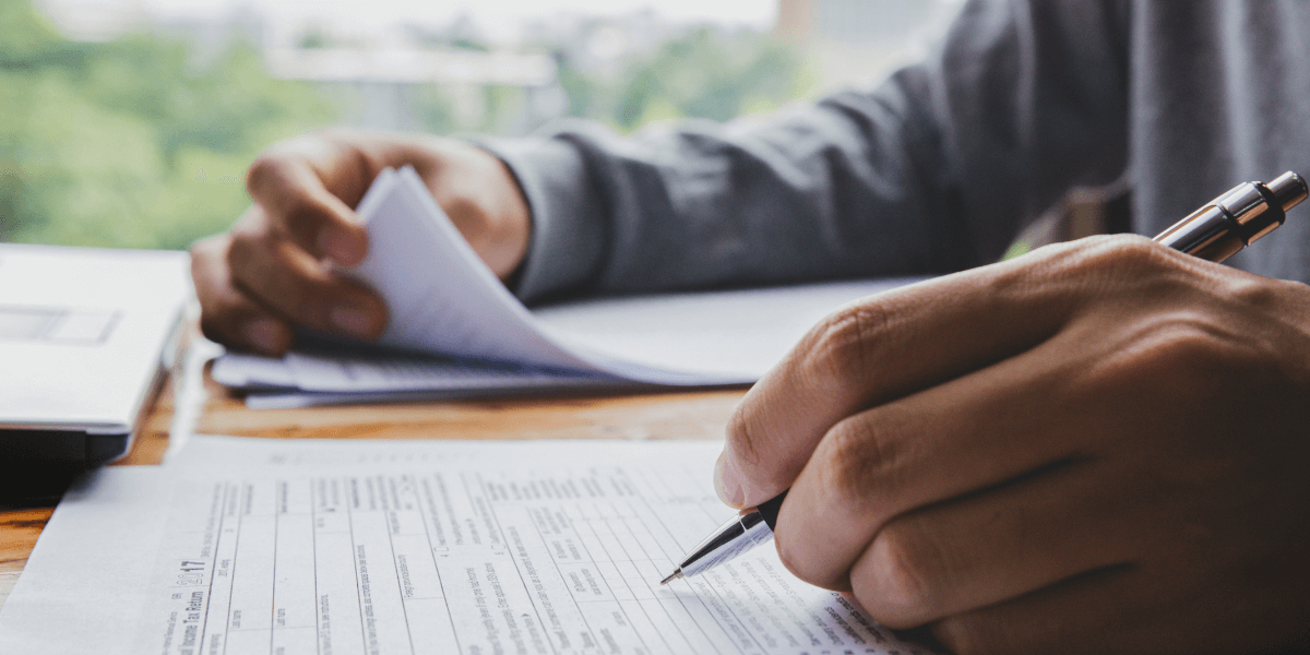 Person filling out tax forms