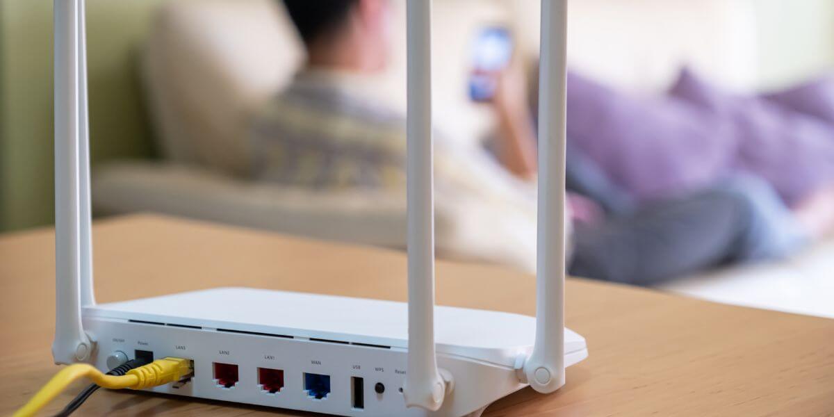 modem with person on phone in background