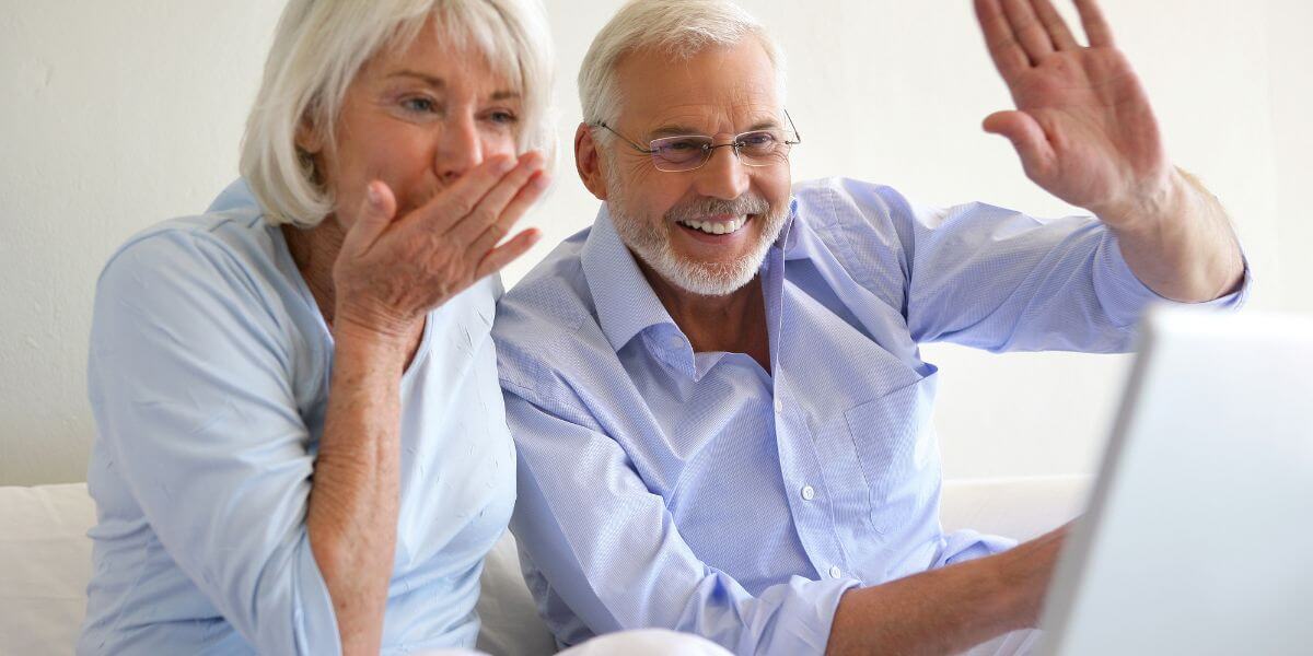 senior internet plans couple waves while on video call