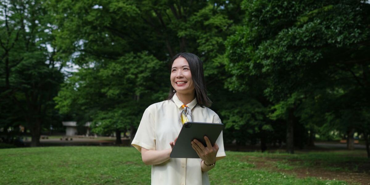 woman standing in yard with tablet