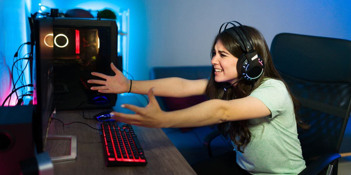 angry female gamer at PC