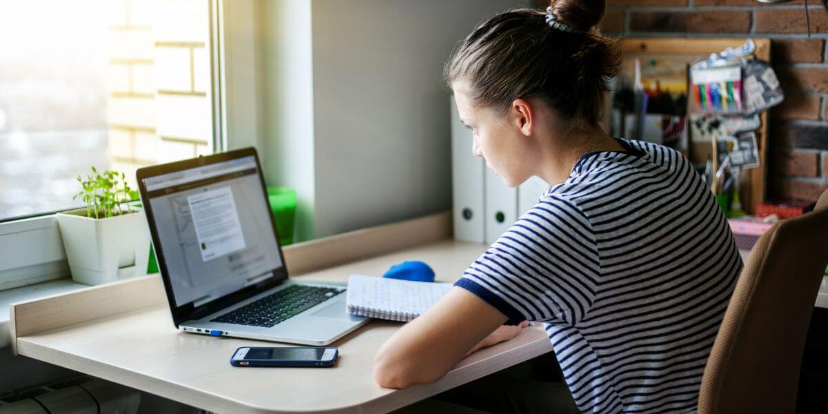 student working on laptop at desk