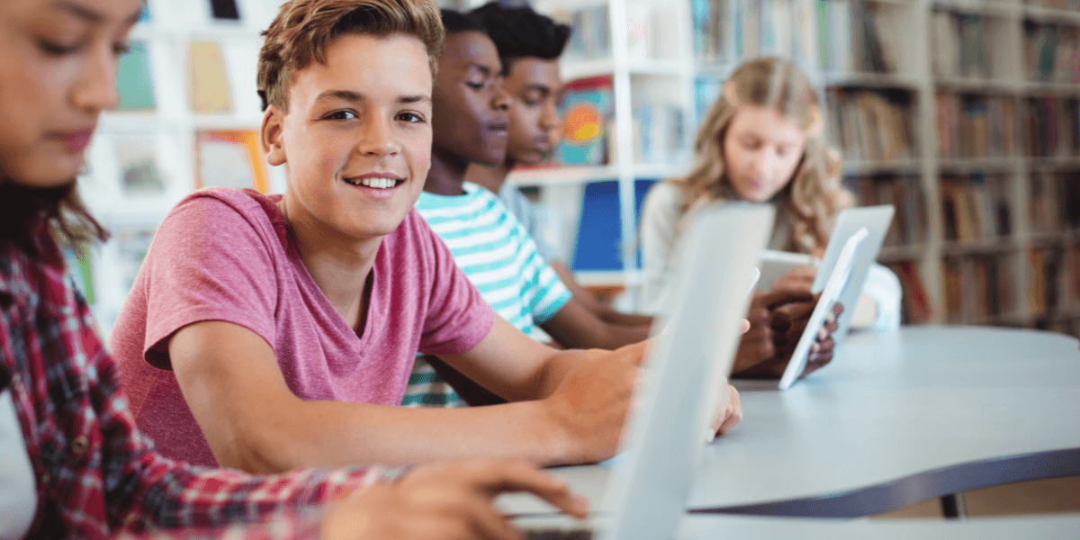 boy in classroom using computer