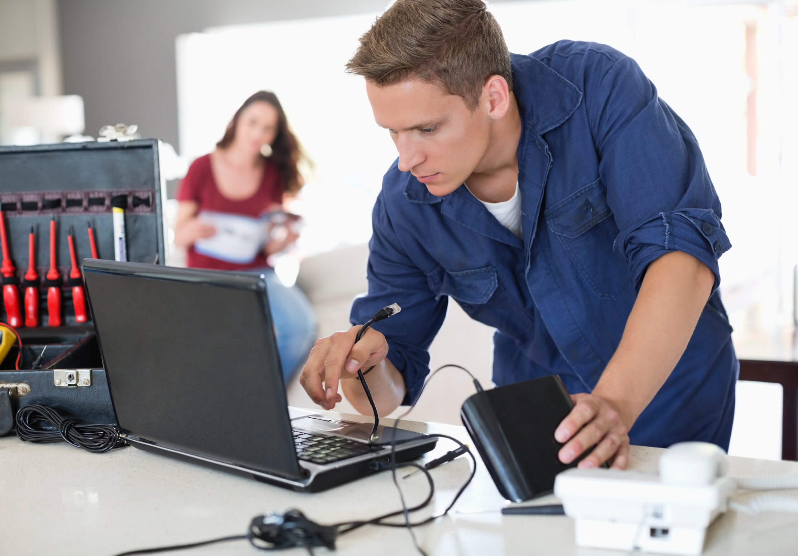 Internet in a new home Electrician using laptop in home