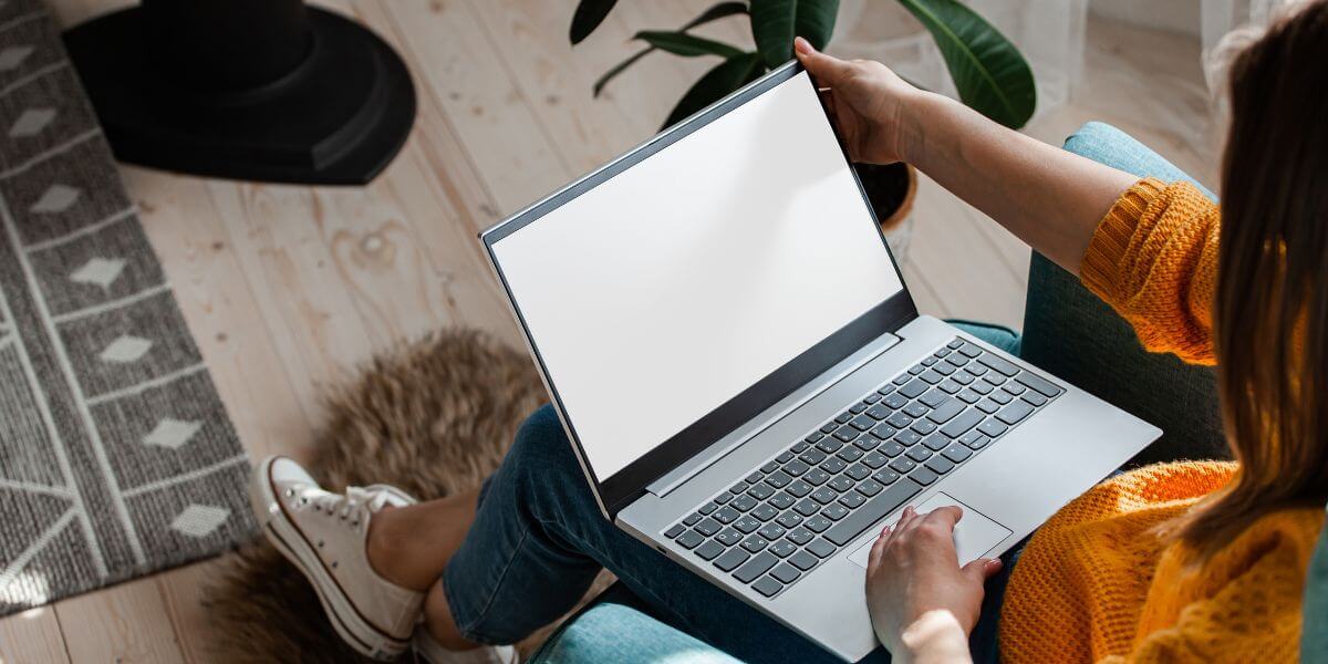 person with laptop on floor