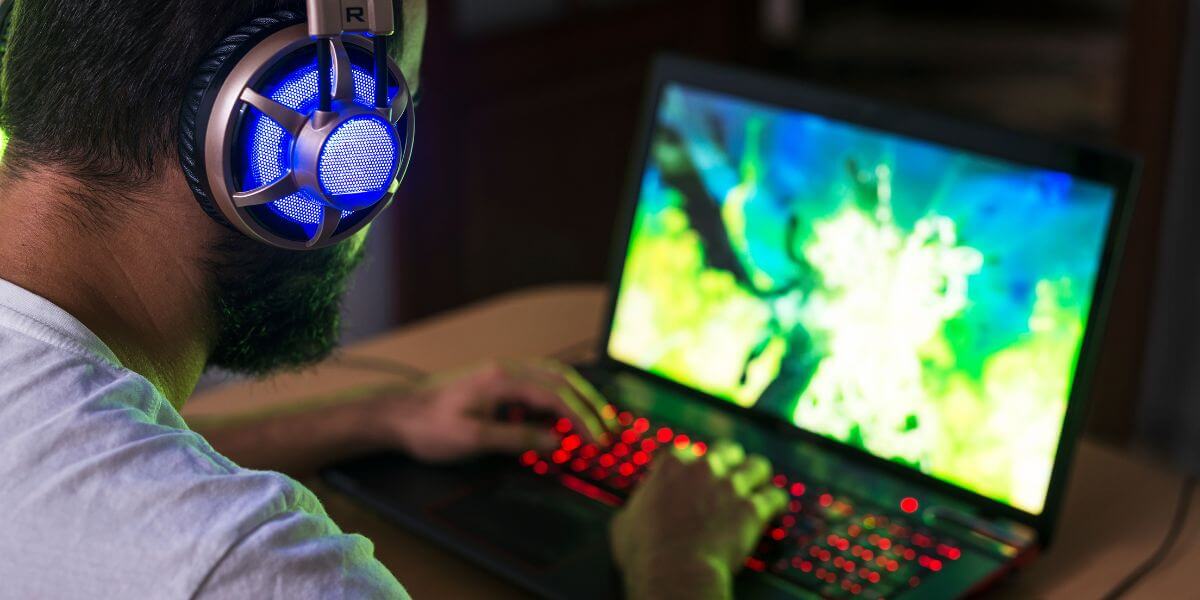 man gaming on laptop