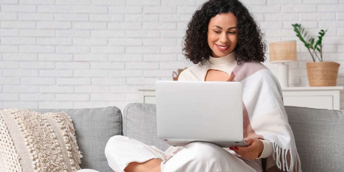 woman on couch using laptop