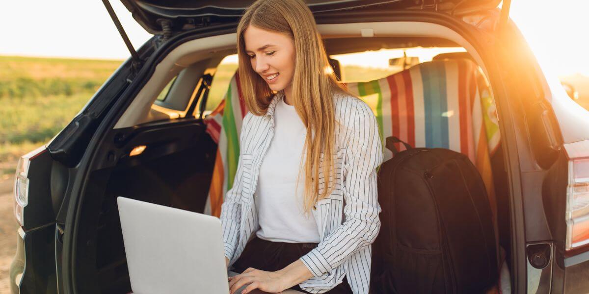 woman using laptop in car