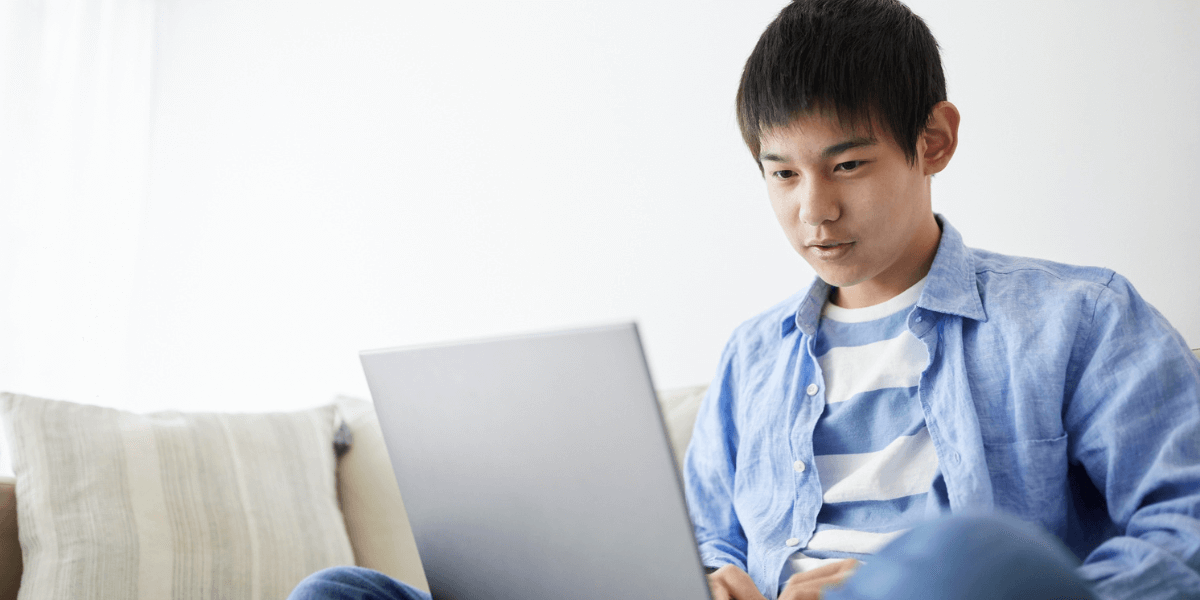 teen boy using laptop