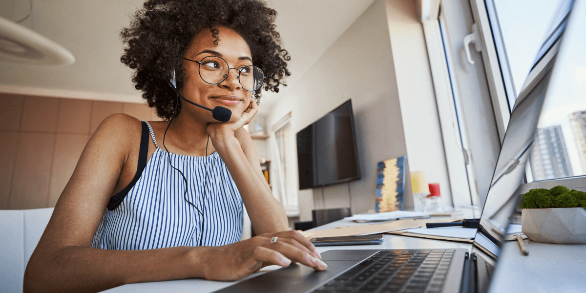 young woman using a headset while working remote