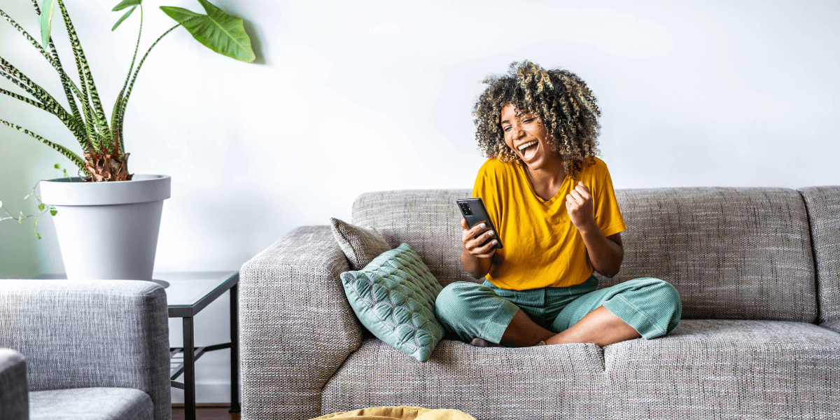 woman looking at her phone smiling