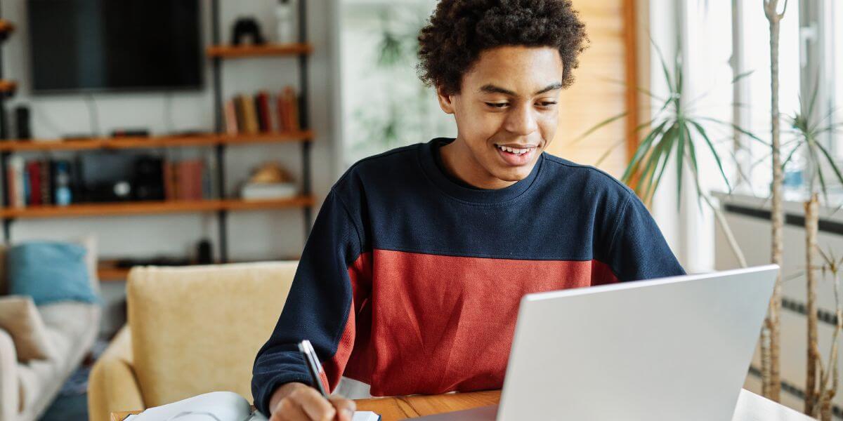 student using laptop at table