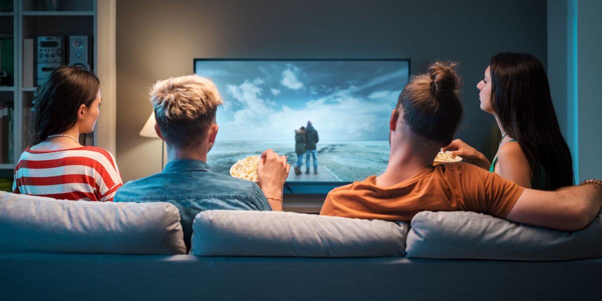 people on couch watching tv