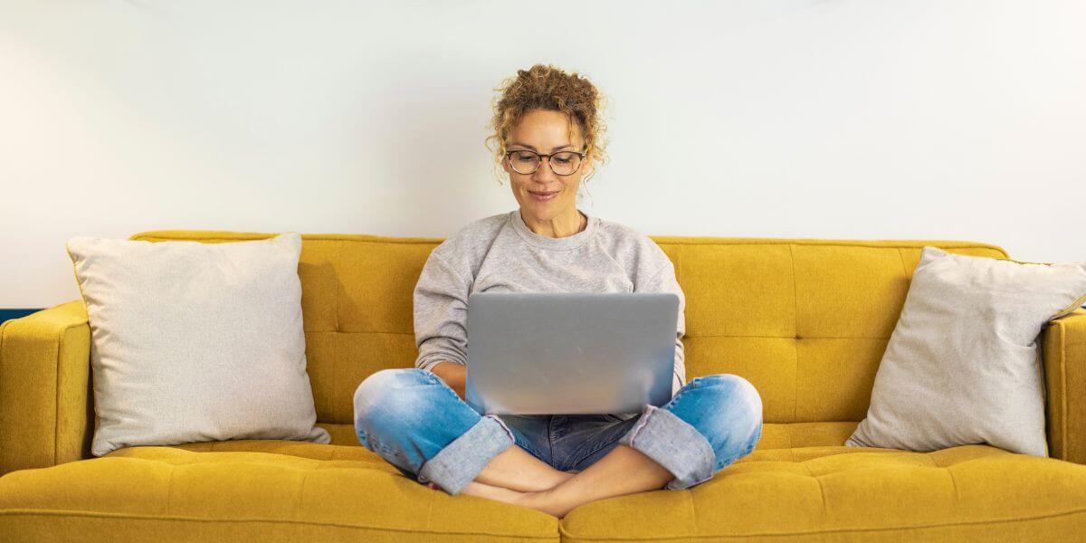 woman using laptop on couch