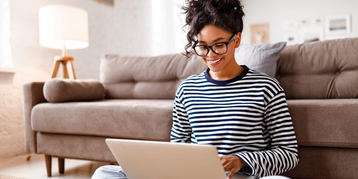 woman using laptop on floor