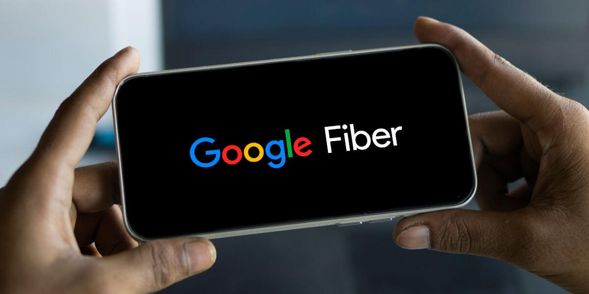 person holding phone showing google fiber