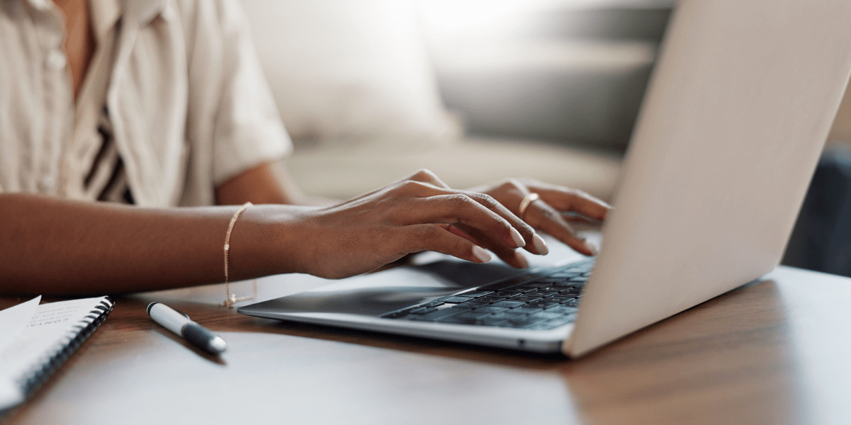 person typing on a laptop