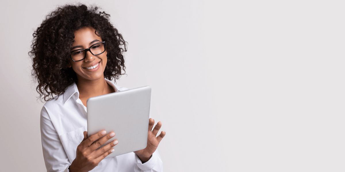 woman smiling at an ipad