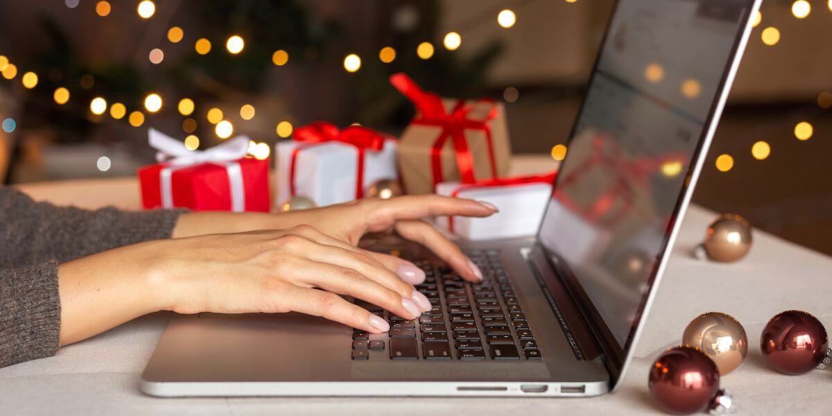 holiday and hands typing on laptop