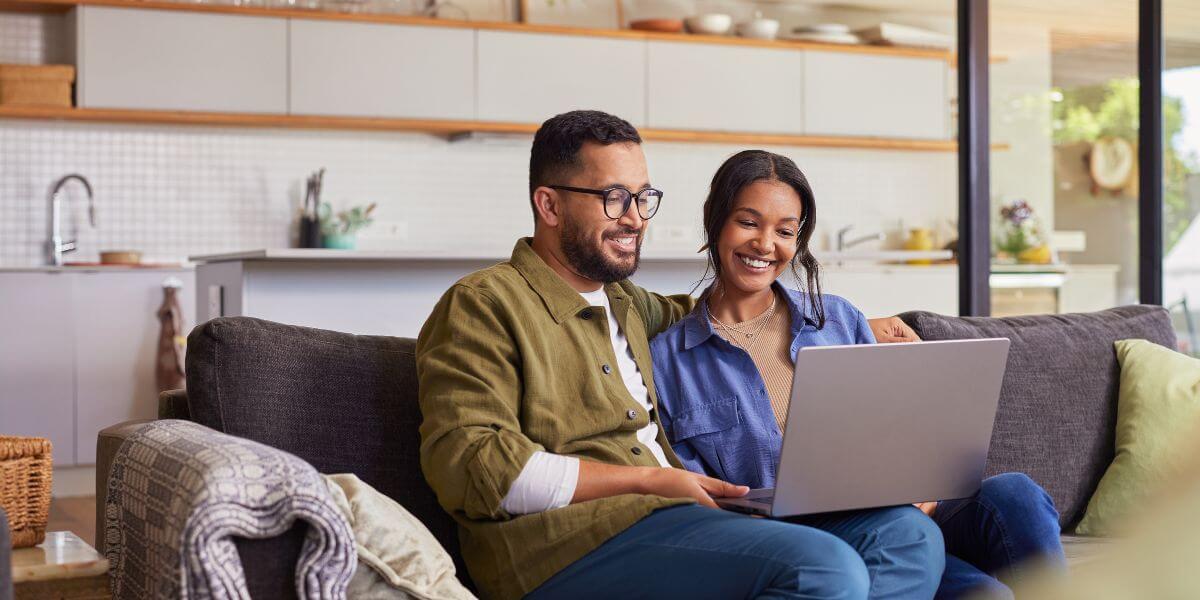 couple on couch with laptop