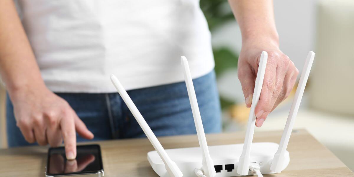 person using phone and router