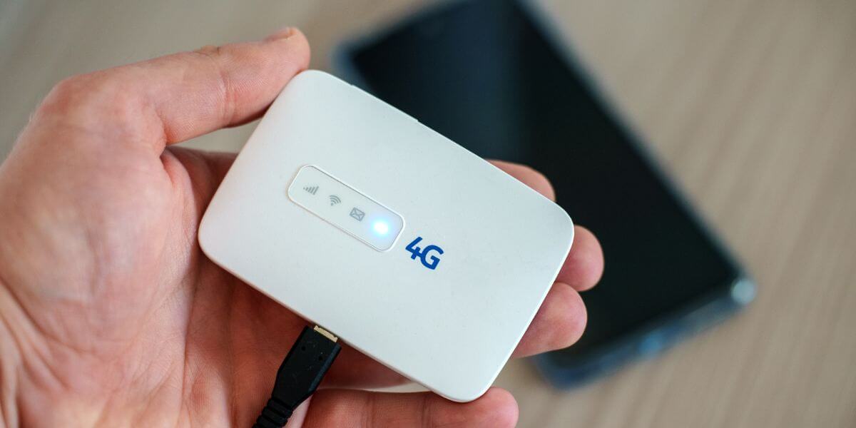 person holding mobile hotpsot