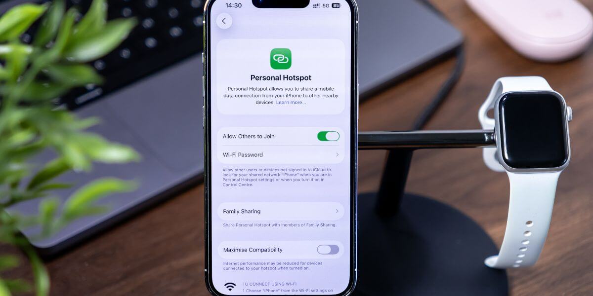 phone and apple watch on stand