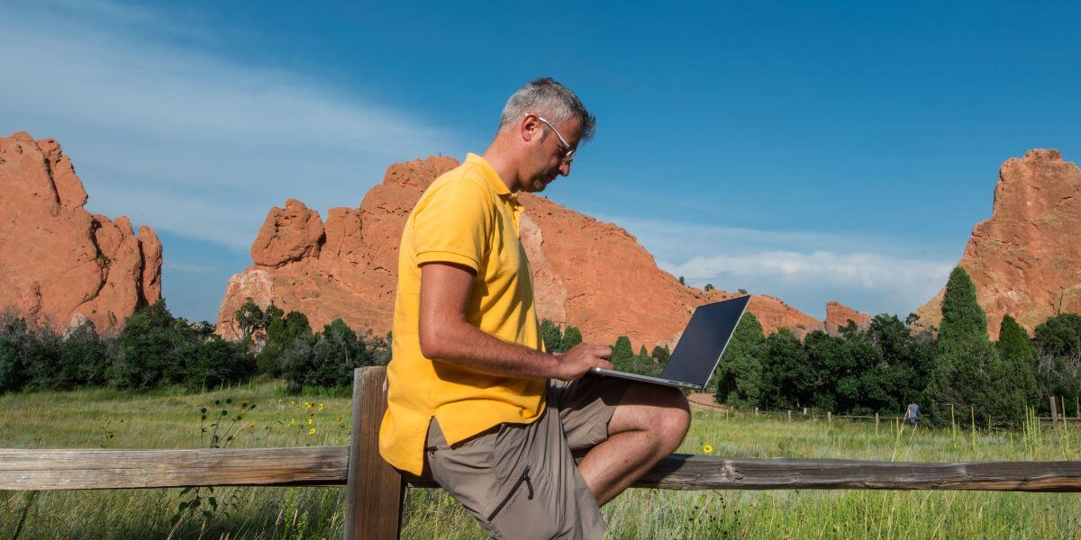 average internet bill Colorado guy on laptop outdoors