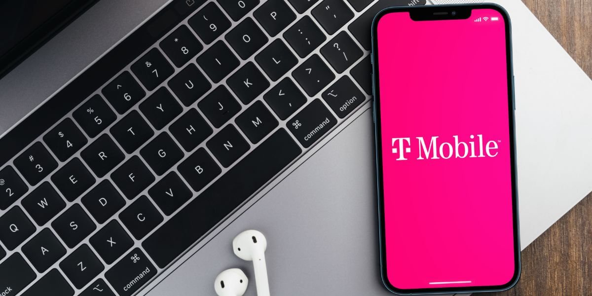 T-Mobile logo on phone on top of laptop
