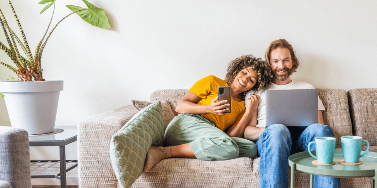 people looking at phone and laptop