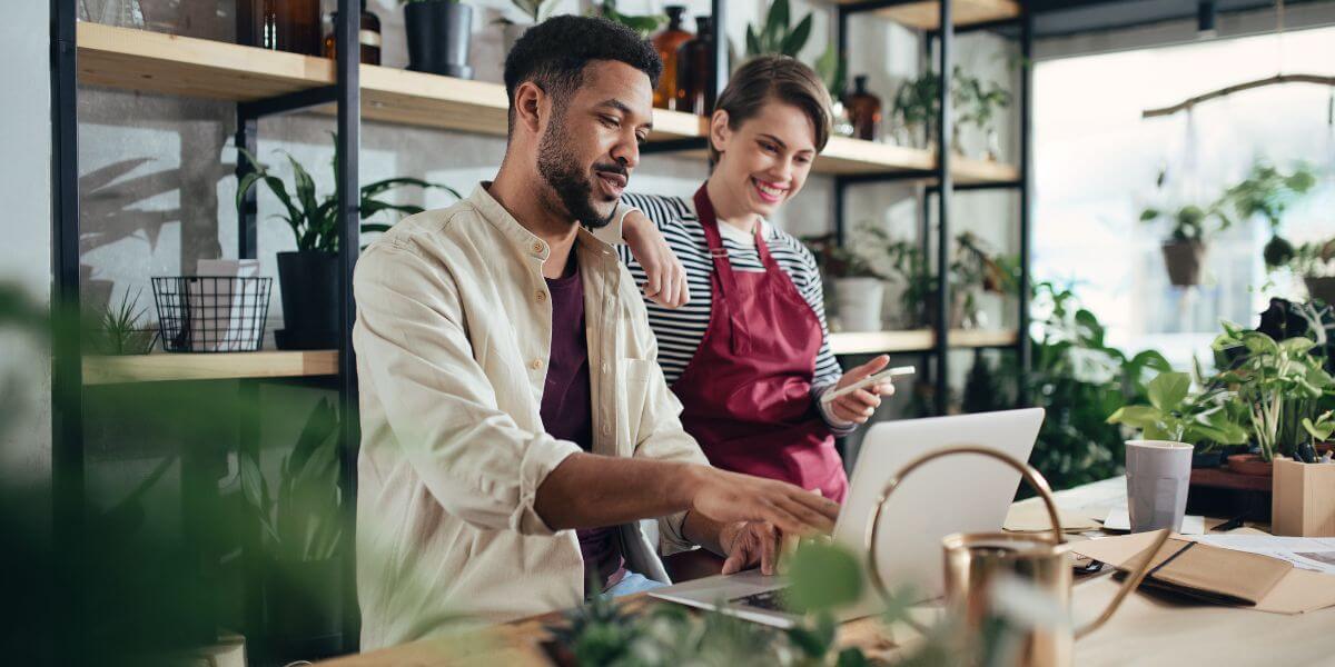 man and woman at laptop at flower shop