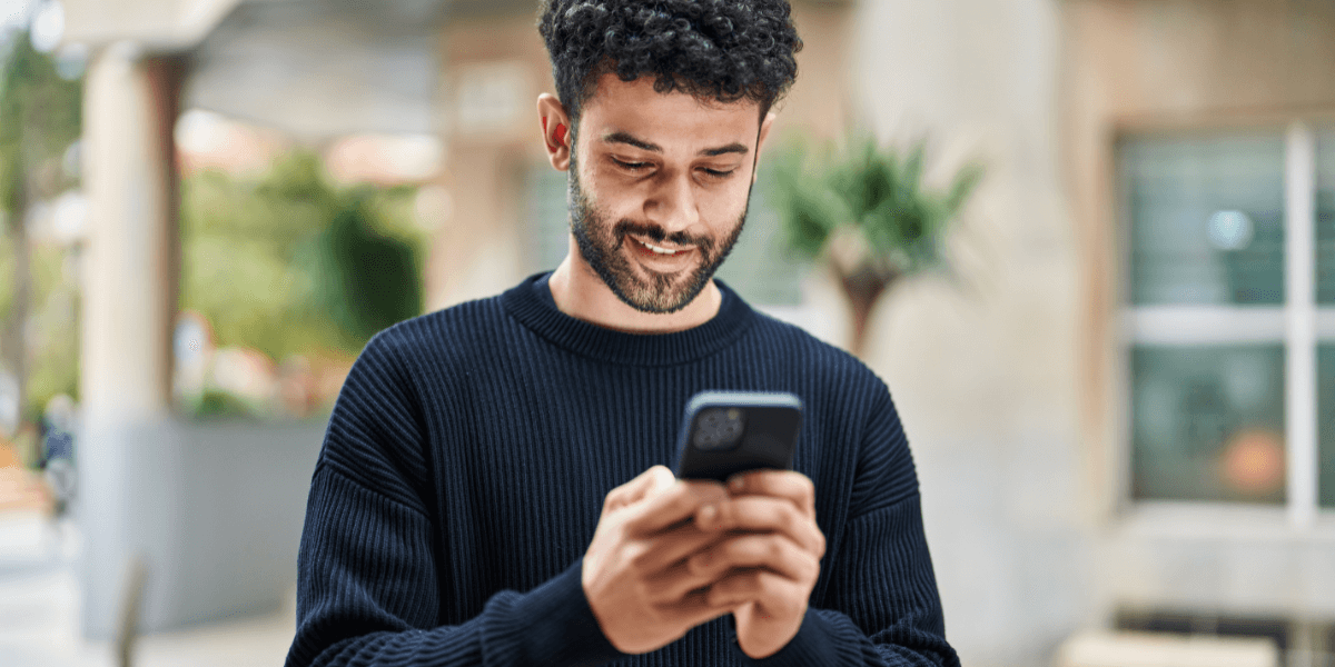 young man looking at his phone