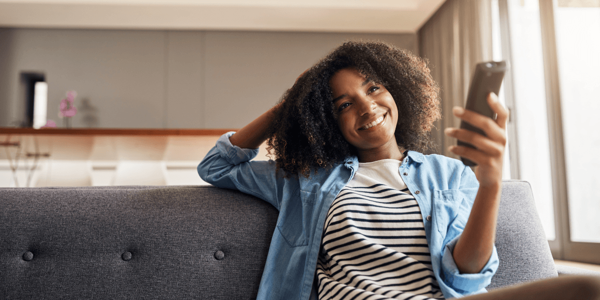 person watching tv with remote in hand