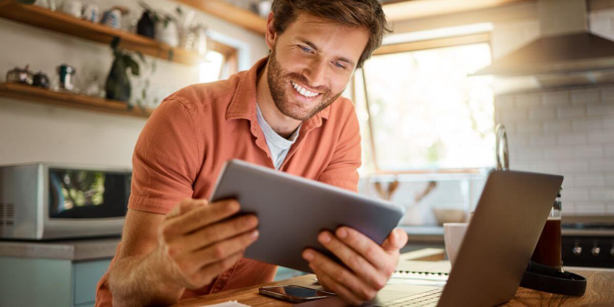 man using tablet and laptop