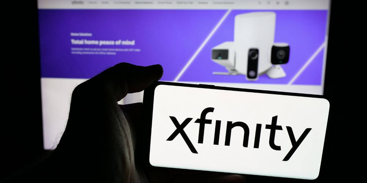 Xfinity logo on phone and monitor in background