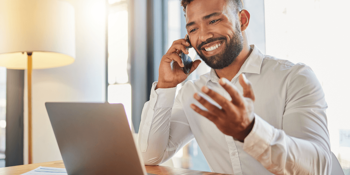 man smiling looking at laptop