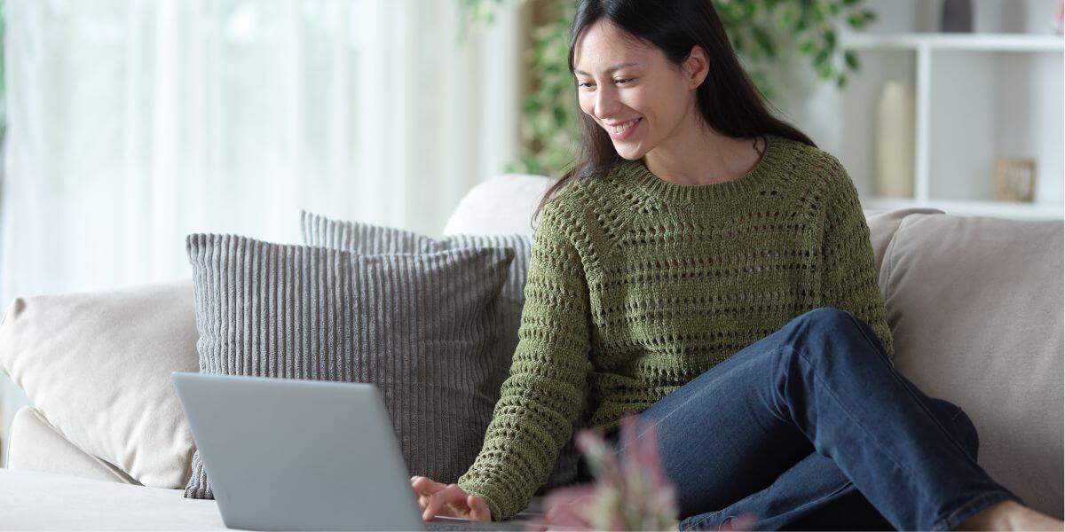 woman using laptop on couch