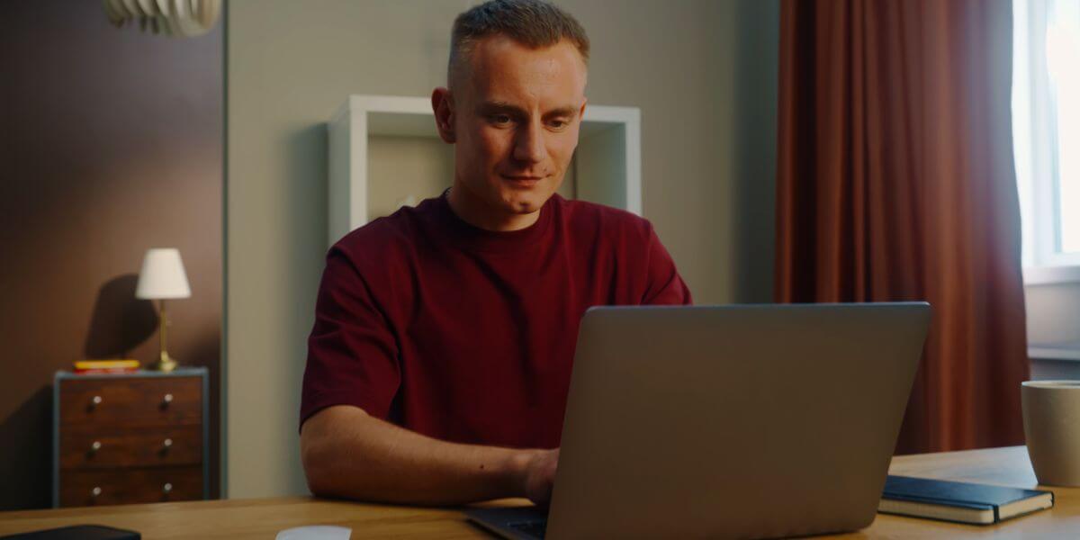 man using laptop at desk