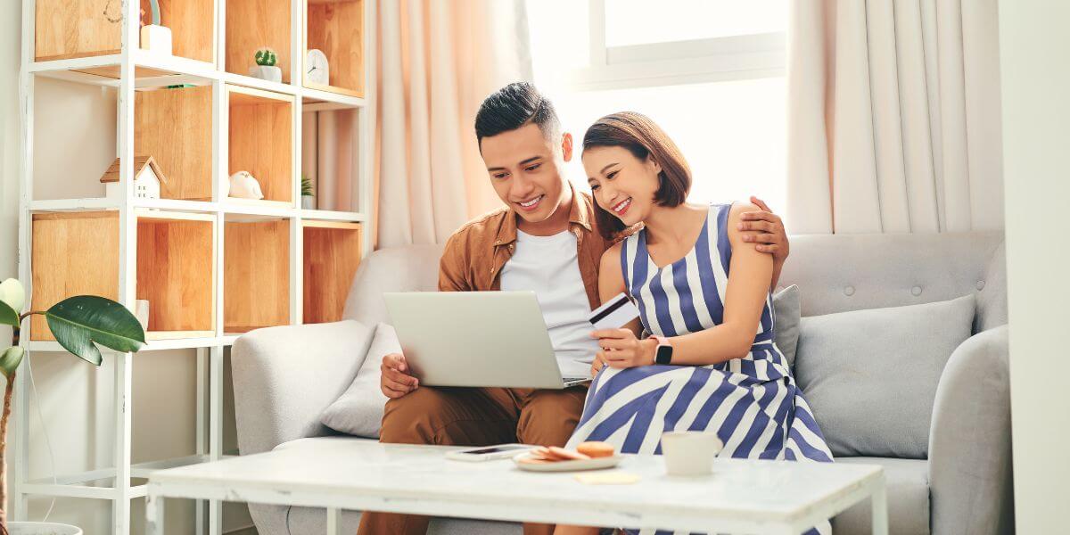 couple on couch using laptop