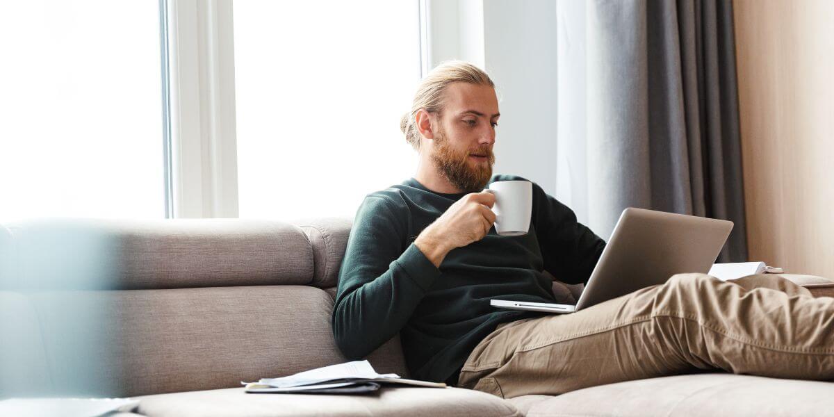 man using laptop on couch