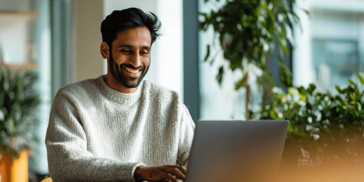 young man with dark hair using a laptop on fiber internet