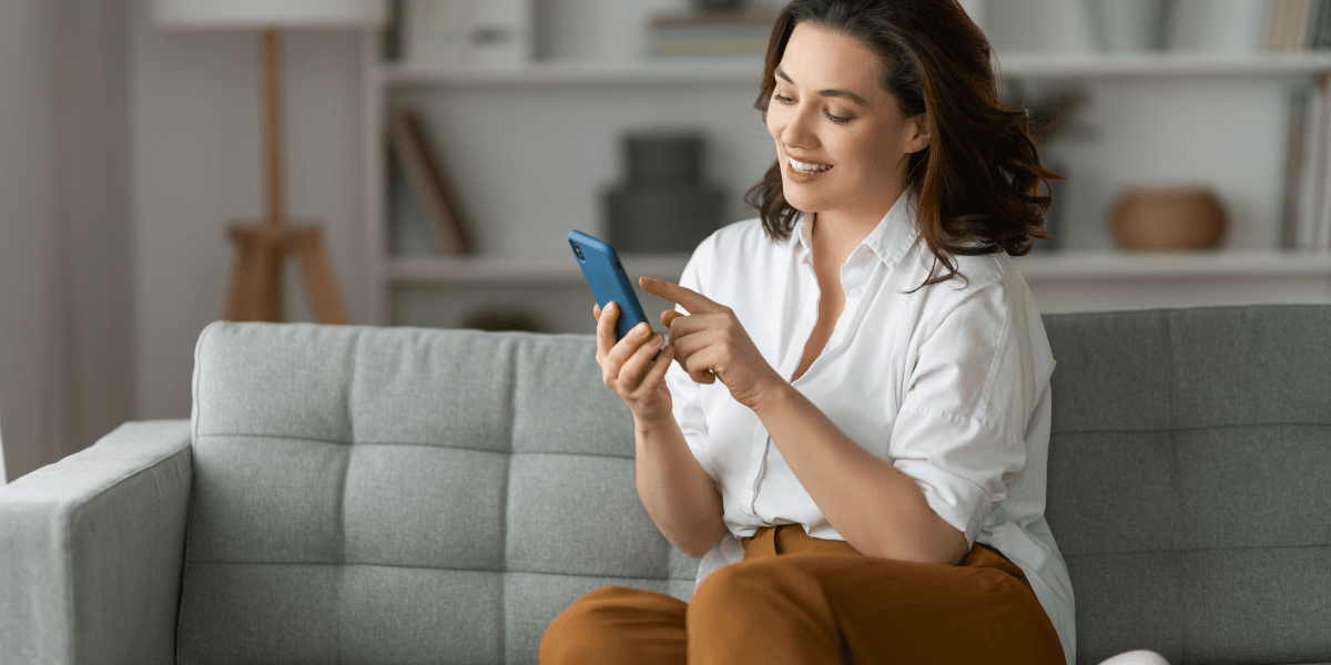 woman smiling at cell phone