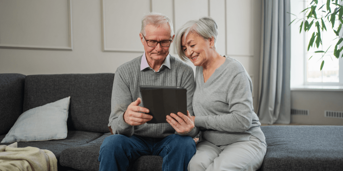an older couple looking at a tablet