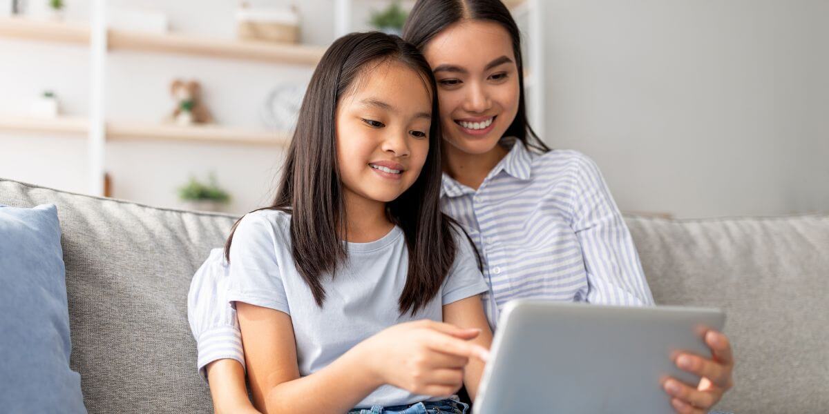 mother and daughter using tablet