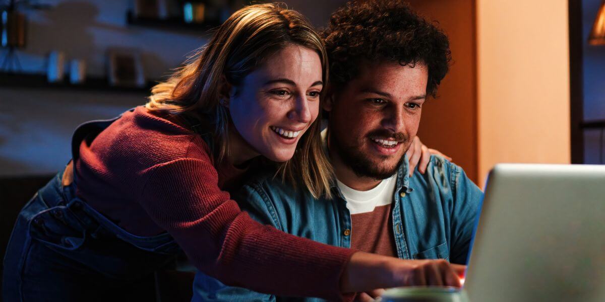 man and woman using laptop