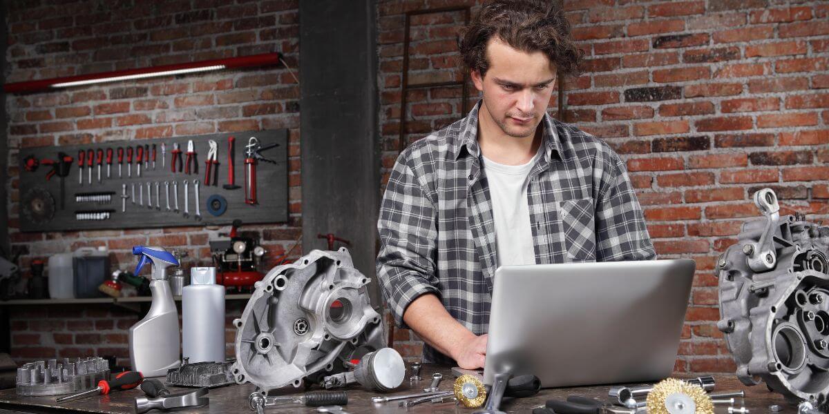 man using laptop in garage
