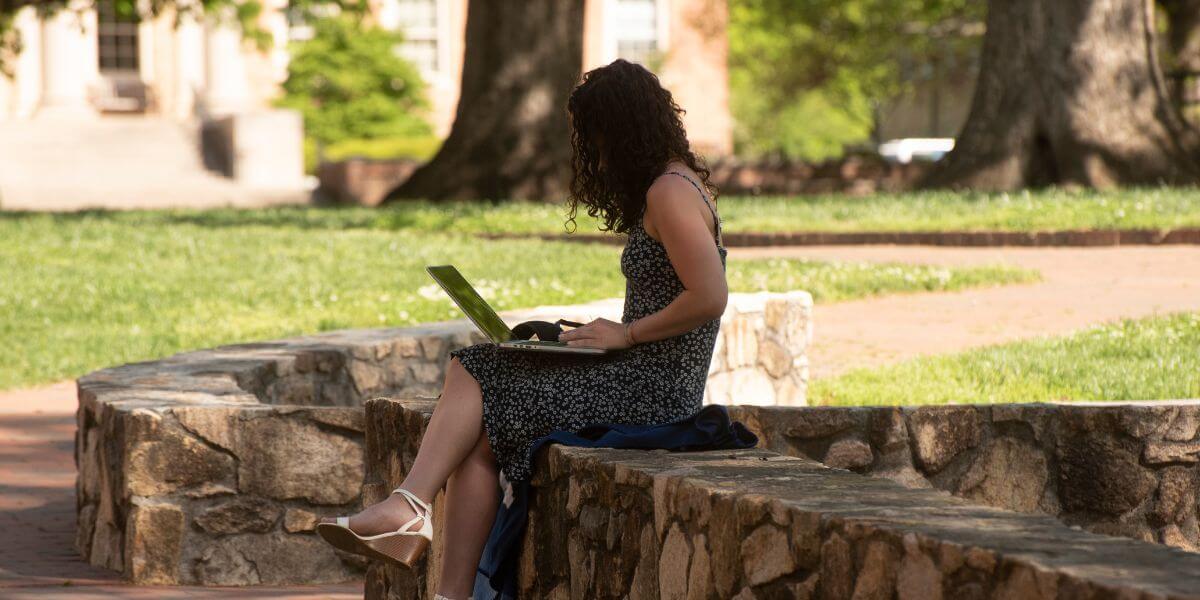 woman working on laptop outside