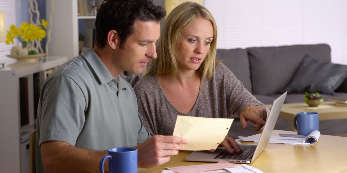 couple at table paying bills